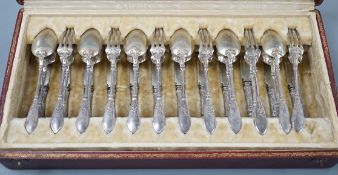 An early 20th century cased set of twelve French 950 standard white metal tea knives, spoons and