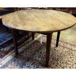 A 19th century French circular pine and oak kitchen table, diameter 116cm, height 74cm