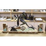 A large Art Deco spelter and marble clock garniture with a figural seaside mount, 59cm tall