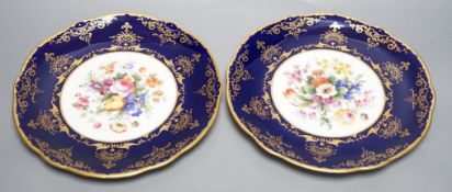 A pair of Coalport floral plates with cobalt blue borders having raised and flat gilding, both by