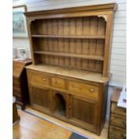 A Victorian pine dresser with boarded rack, length 182cm, depth 46cm, height 223cm