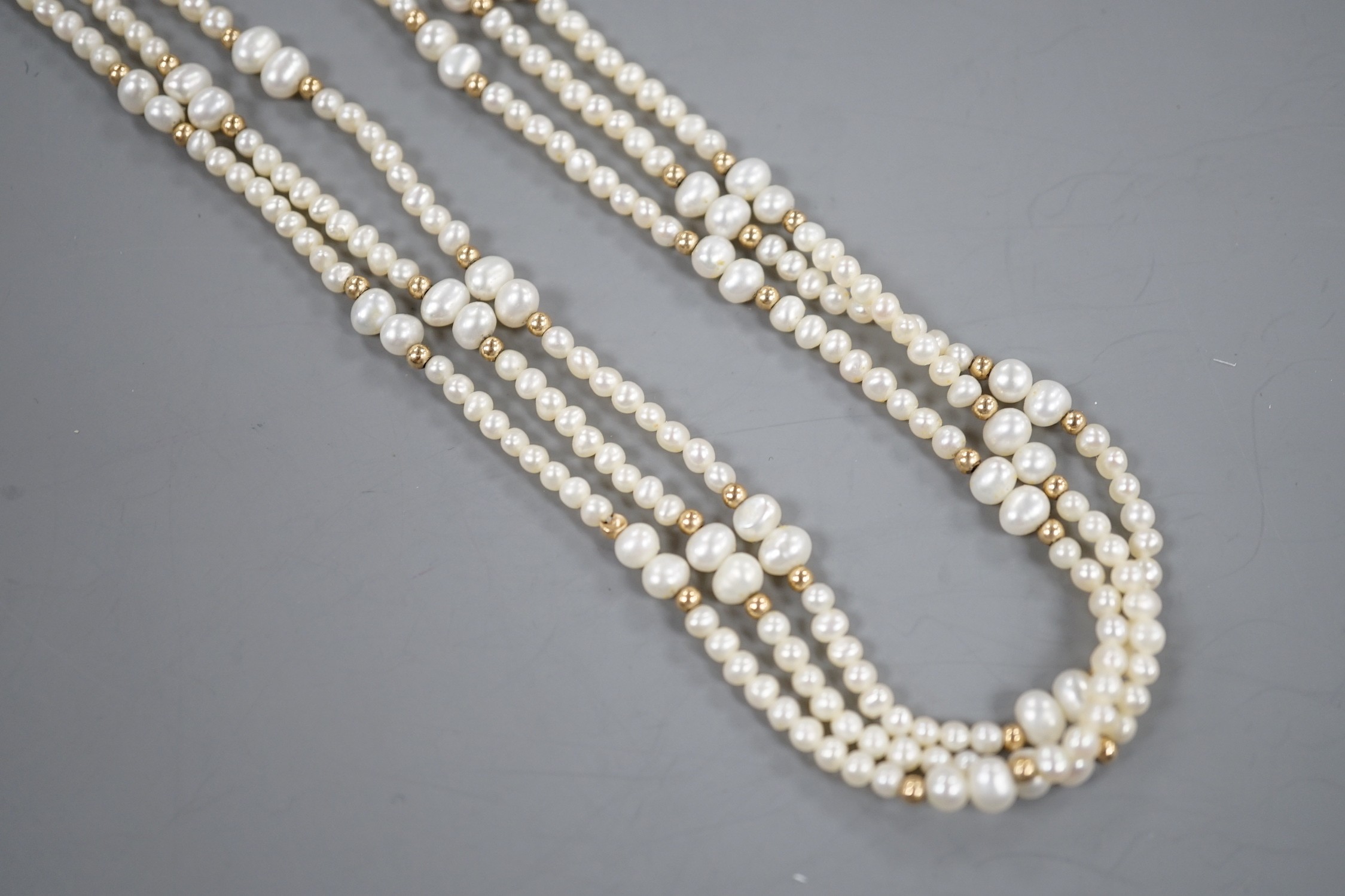 A modern 9k mounted triple strand cultured pearl necklace, 39cm, with yellow metal spacers. - Image 3 of 3