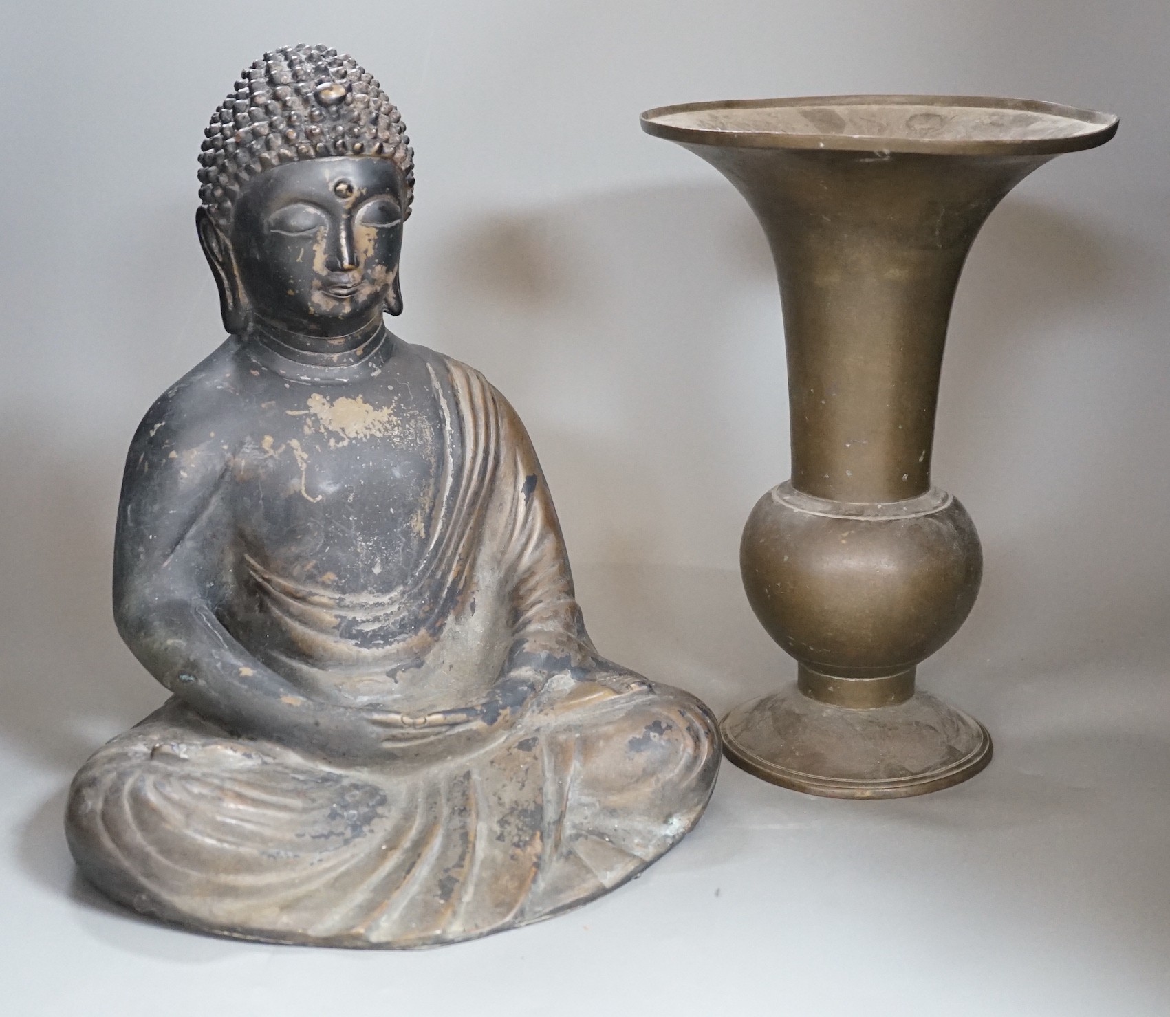 A Chinese bronze seated Buddha and a similar gu vase, tallest 30cm