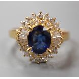 A modern 750 yellow metal, sapphire and diamond set oval cluster ring, size H, gross weight 4.6