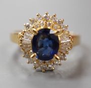 A modern 750 yellow metal, sapphire and diamond set oval cluster ring, size H, gross weight 4.6