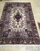 A Persian style red and cream ground wool rug, 207x 130cm
