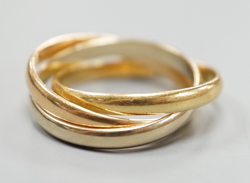 A modern Cartier three colour 750 yellow metal 'Russian' triple wedding ring, size U, 8.5 grams.