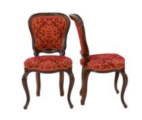 A set of twelve Victorian mahogany balloon back dining chairs, with floral carved show wood