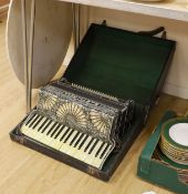 A cased Santiarelli cased accordion,51 cms wide,