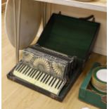 A cased Santiarelli cased accordion,51 cms wide,