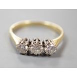 A modern 18ct gold and three stone diamond ring, size O, gross weight 2.5 grams.
