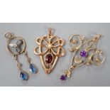 Three assorted early 20th century yellow metal and gem set pendants, including 9ct garnet and