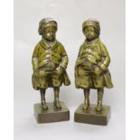 Two green patinated bronze figures of a boy. 18.5cm