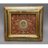 An 18th century century Italian scrolled paper and metal thread picture, in a polychrome and gilt