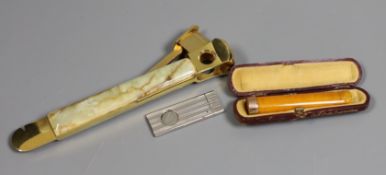 An onyx and gilt-metal cigar cutter, a smaller plated cheroot cutter and a cased 9ct mounted cheroot