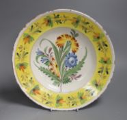 A German polychrome faience floral dish, Kellinghusen, 19th century, 31cm