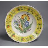 A German polychrome faience floral dish, Kellinghusen, 19th century, 31cm