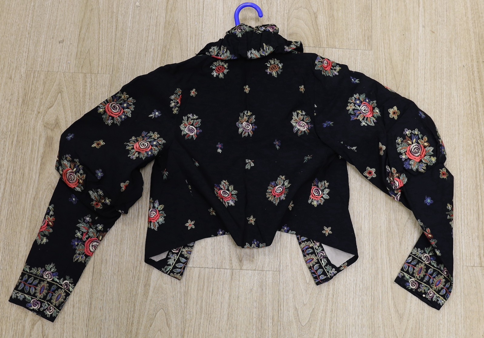 A 1930's-40's black evening jacket, embroidered with multi coloured floral embroidery, together with - Image 2 of 2