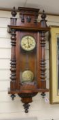 A 19th century German architectural beech and walnut wall clock,100 cms high,