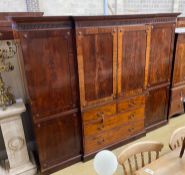 An Edwardian mahogany breakfront wardrobe, with two doors enclosing trays and four drawers flanked