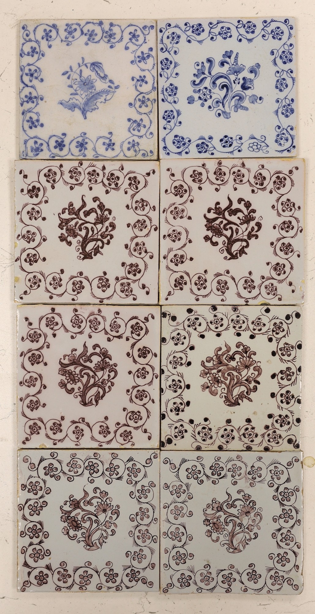 Six 18th/19th century Delft manganese flower spray tiles and two similar blue and white tiles,