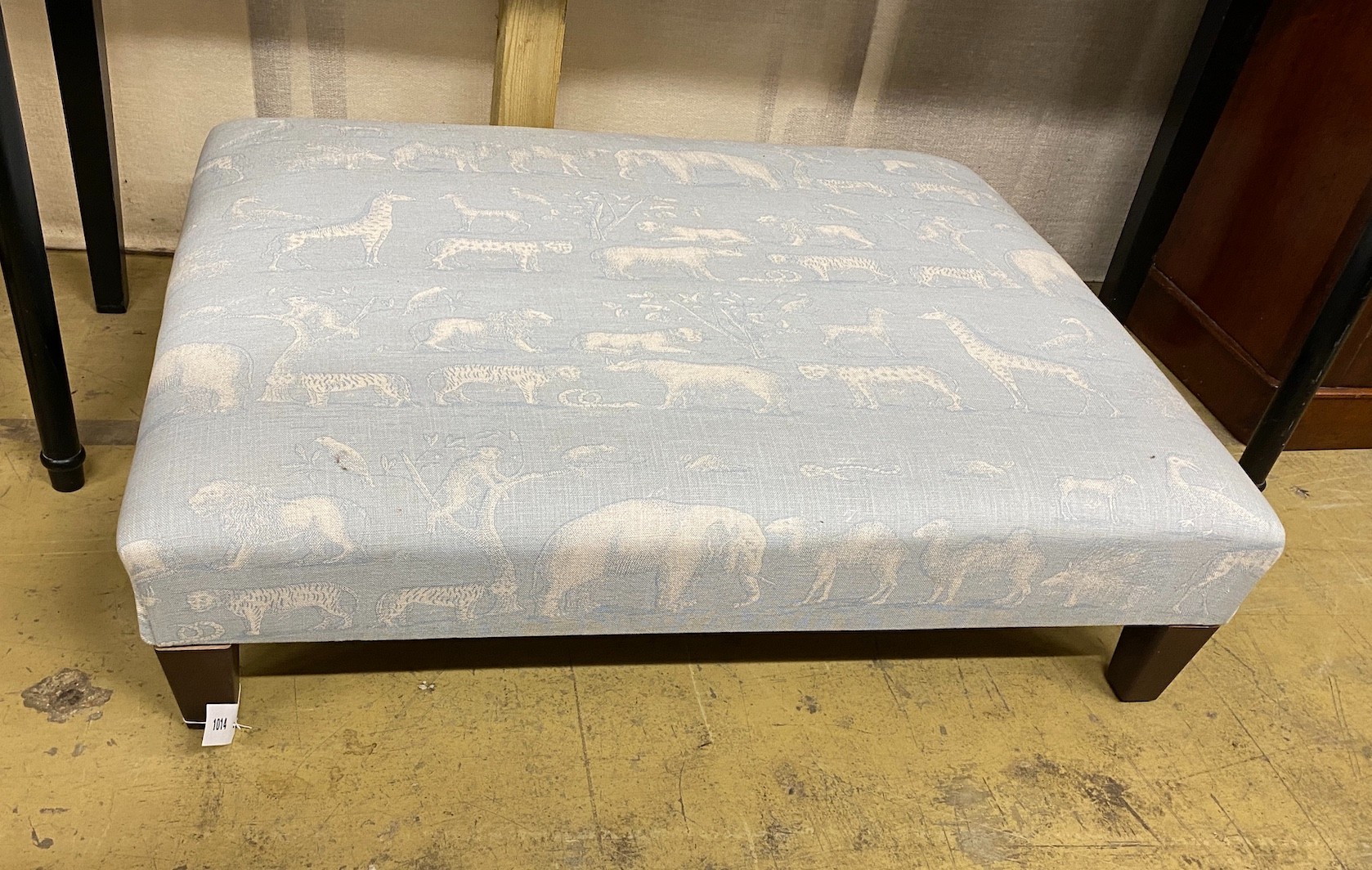 A contemporary rectangular footstool upholstered in Andrew Martin animal print fabric, width