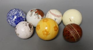 Three carpet bowls, three sports balls and a polo ball,