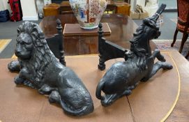 Two cast iron fire ornaments modelled as heraldic lion and unicorn, width 62cm