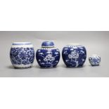 A pair of Chinese blue and white prunus jars, one with cover, a similar smaller jar and a ‘barrel’