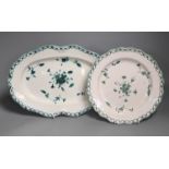 An 18th century French faience green camaieu oval serving dish and a similar plate, largest 36cm