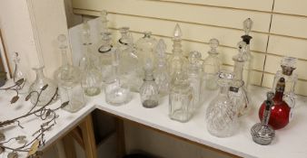 A quantity of various glass decanters, some silver mounted