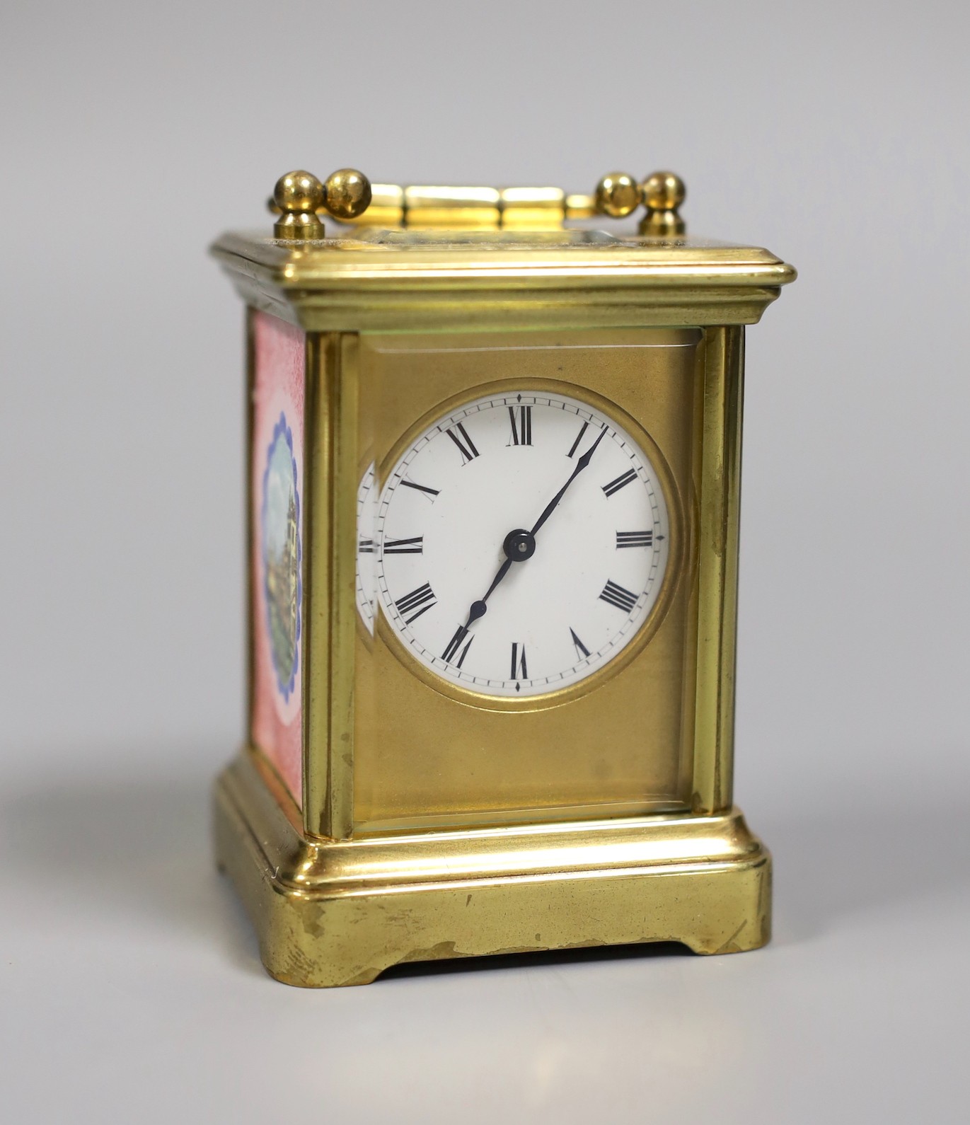 A miniature carriage timepiece, with enamelled side panels of Venice, 8 cms high,