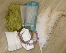 Two 1920's floral bead headdresses, a baby dress, gold fabric, two feathers and three prs of