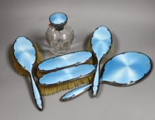 A George V silver and two colour enamel mounted blue enamel mirror and brush set, including a