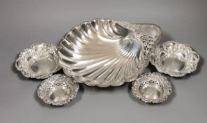 An Edwardian Art Nouveau silver shell dish, with pierced handle, on ball feet, Atkin Brothers,