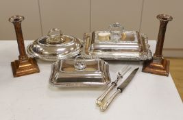 Three silver plated entrée dishes, a pair of candlesticks and a carving knife and fork, largest