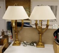 A pair of giltwood three branch lamps, 76 cms high,