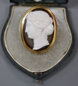 A Victorian yellow metal mounted agate cameo oval brooch, carved with the head of a lady to