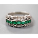 A modern 18k white metal, emerald and baguette cut diamond set three row half hoop ring (shank cut),