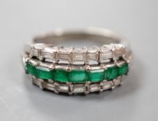 A modern 18k white metal, emerald and baguette cut diamond set three row half hoop ring (shank cut),