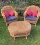 A pair of rattan conservatory chairs and a matching low table