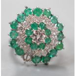 A modern 18ct white gold emerald and diamond cluster set dress ring, (emerald missing), size J,