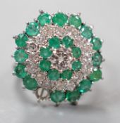 A modern 18ct white gold emerald and diamond cluster set dress ring, (emerald missing), size J,