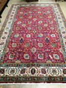 A Tabriz style red ground carpet, 315 x 198cm