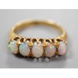 A 18ct and graduated five stone oval white opal set half hoop ring, size L, gross weight 3.8 grams.