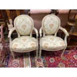 A pair of Louis XVI style cream painted fauteuils, width 58cm, height 90cm
