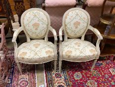 A pair of Louis XVI style cream painted fauteuils, width 58cm, height 90cm