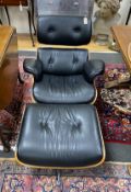 An Eames-style black leather armchair and footstool