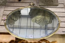 An Edwardian oval gilt metal framed mirror, width 79cm