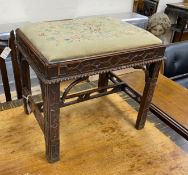 A Chippendale revival mahogany dressing stool with needlework drop in seat and blind fret carving,